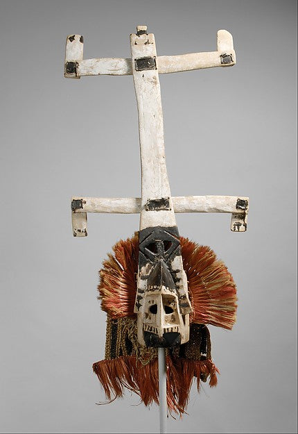 Dogon kanaga masks performing ritual dance in Mali village plaza at sunset